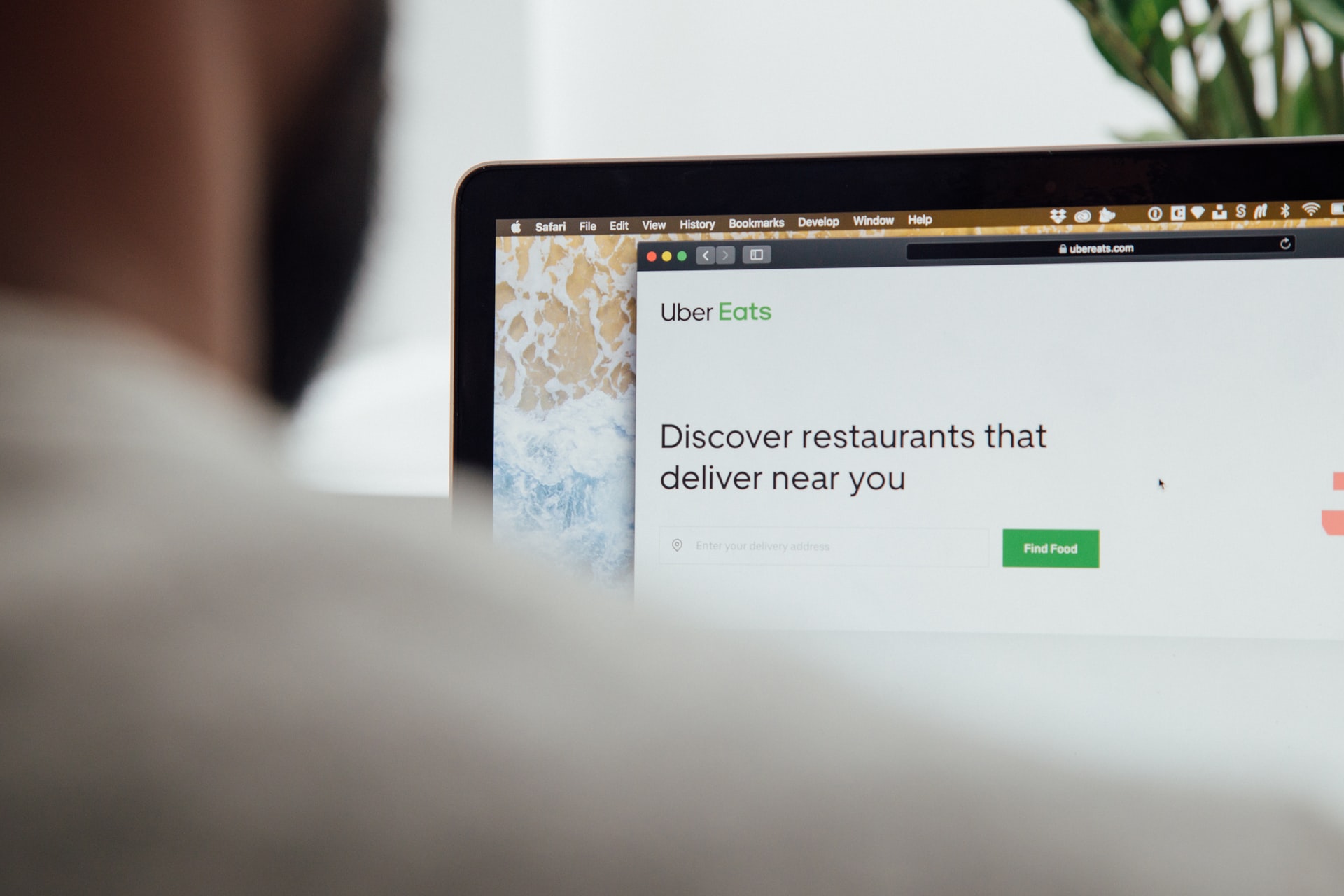 A person beginning an order with UberEATS on a laptop screen