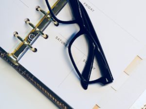 Glasses on an open calendar representing CRA extensions due to COVID