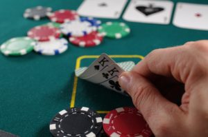 poker player checks the cards in his hand